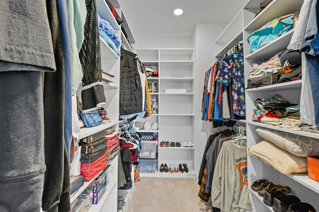 2128 Raglan Circle Ormond Beach, FL 32174 - Photo 22 of 55 a view of walk in closet with clothes and shoes