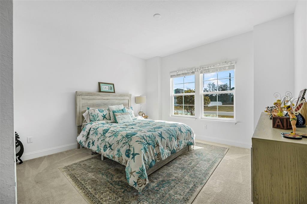 2128 Raglan Circle Ormond Beach, FL 32174 - Photo 24 of 55 a bedroom with a bed and a dresser next to a window