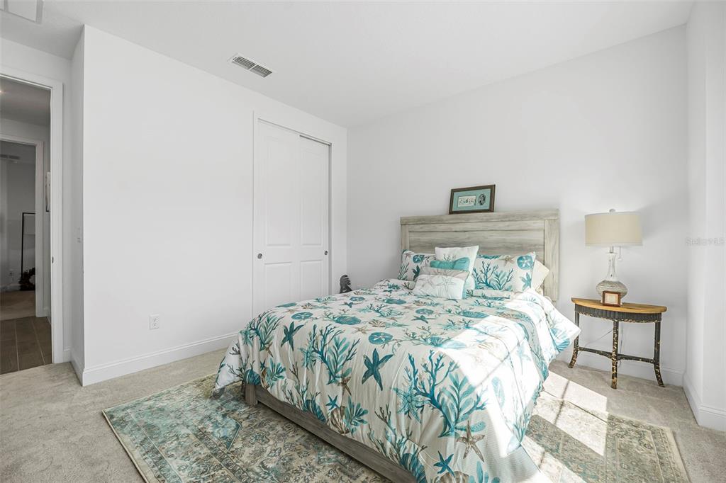 2128 Raglan Circle Ormond Beach, FL 32174 - Photo 25 of 55 a bedroom with a bed and a lamp