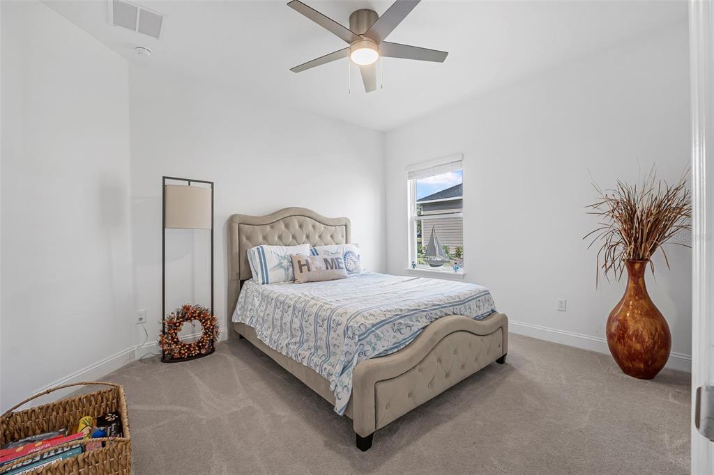 2128 Raglan Circle Ormond Beach, FL 32174 - Photo 30 of 55 a bedroom with a bed and a chandelier