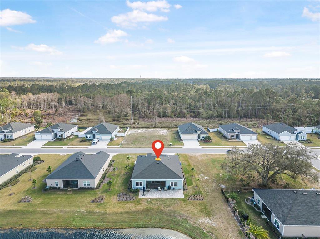 2128 Raglan Circle Ormond Beach, FL 32174 - Photo 49 of 55 an aerial view of a house with a yard swimming pool and mountains