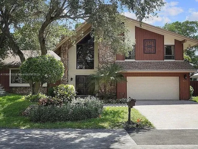 a front view of a house with garden