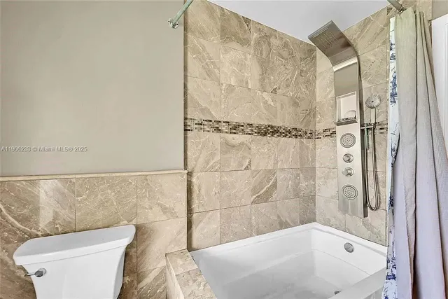 a bathroom with a bathtub and shower