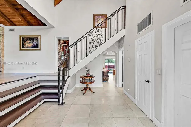 a view of entryway with stairs and wooden floor