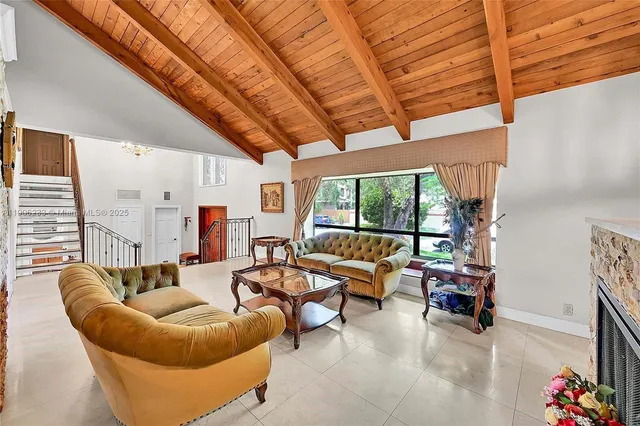 a living room with furniture and a floor to ceiling window