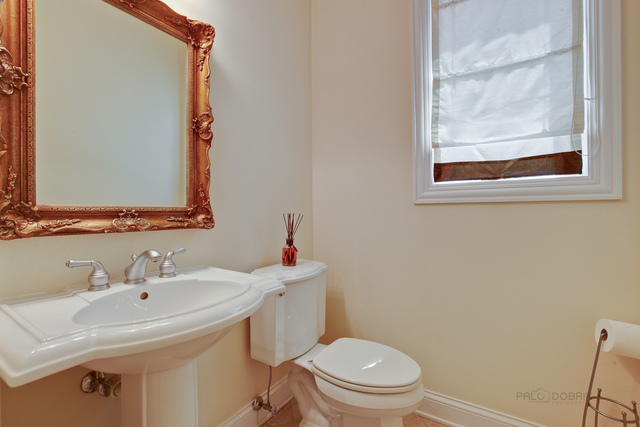 1007 Whitfield Road Northbrook, IL 60062 - Photo 14 of 27 a bathroom with a sink and a toilet