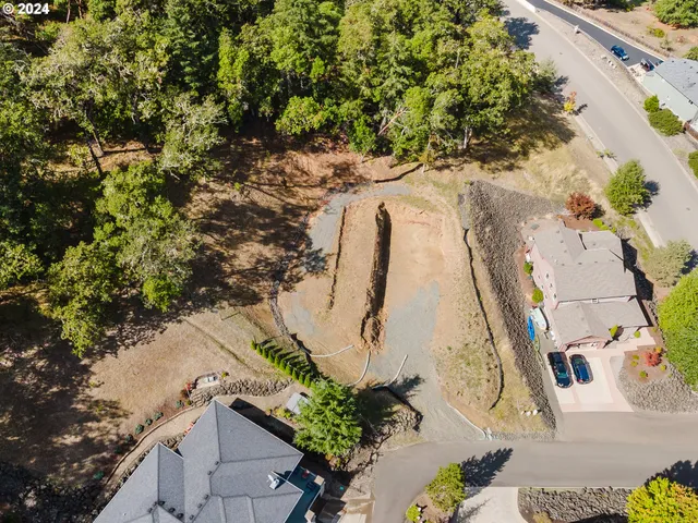 an aerial view of a house with a yard and garden