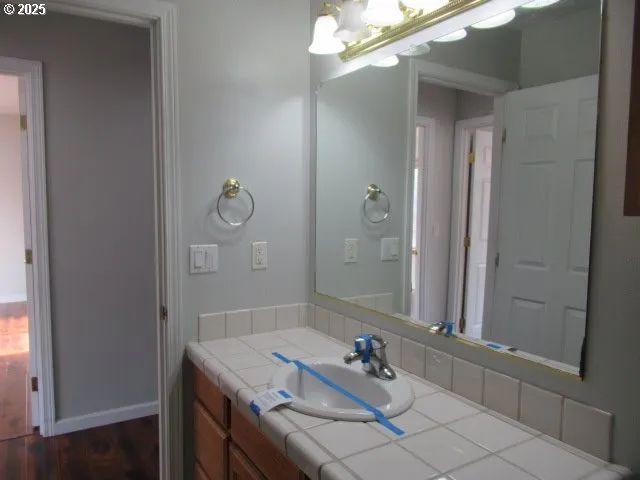 a bathroom with a sink vanity and mirror