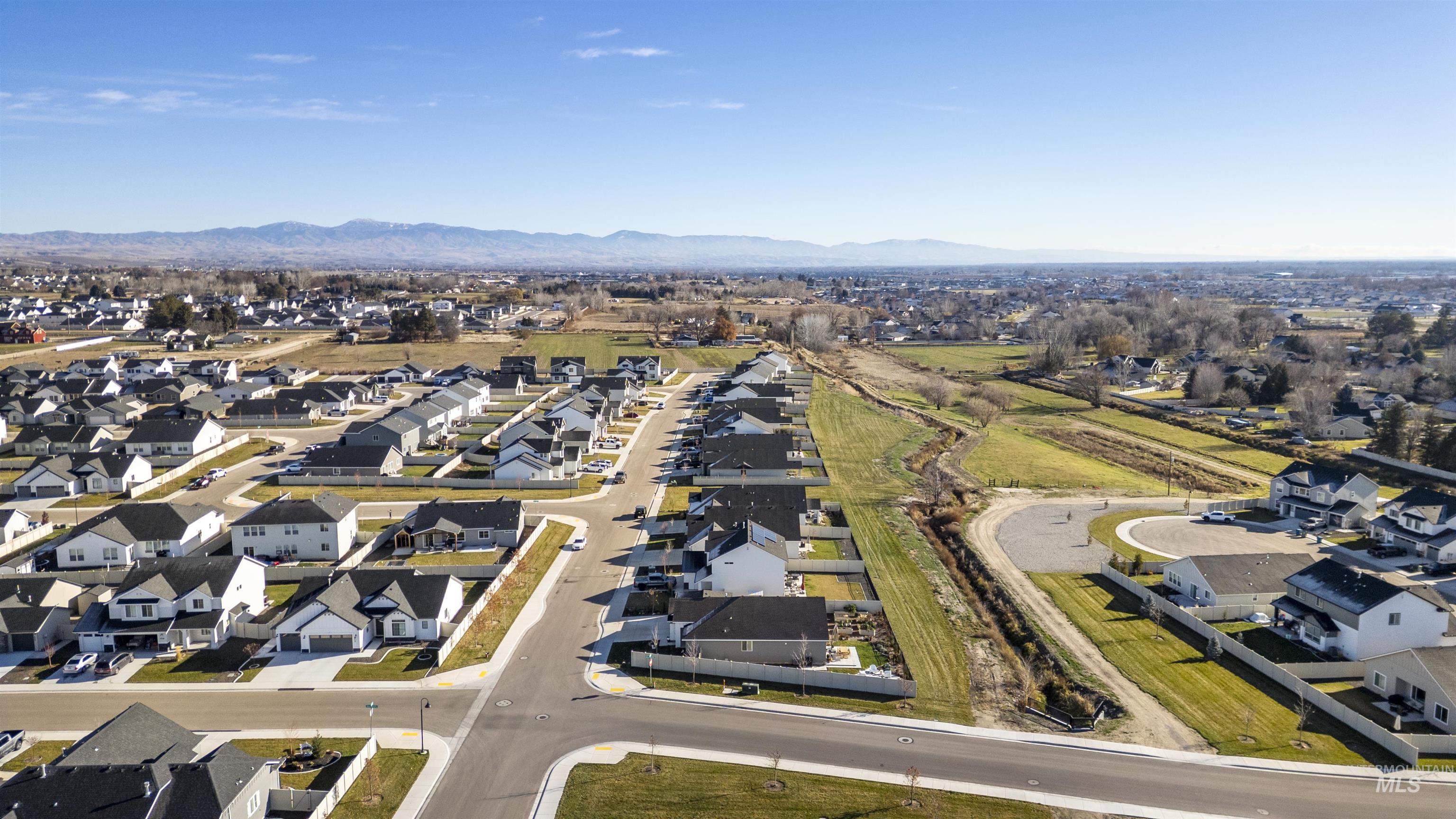 11289 West Langit Street Star, ID 83669 - Photo 30 of 33 Aerial overview of property's location with nearby suburban area and a mountainous background
