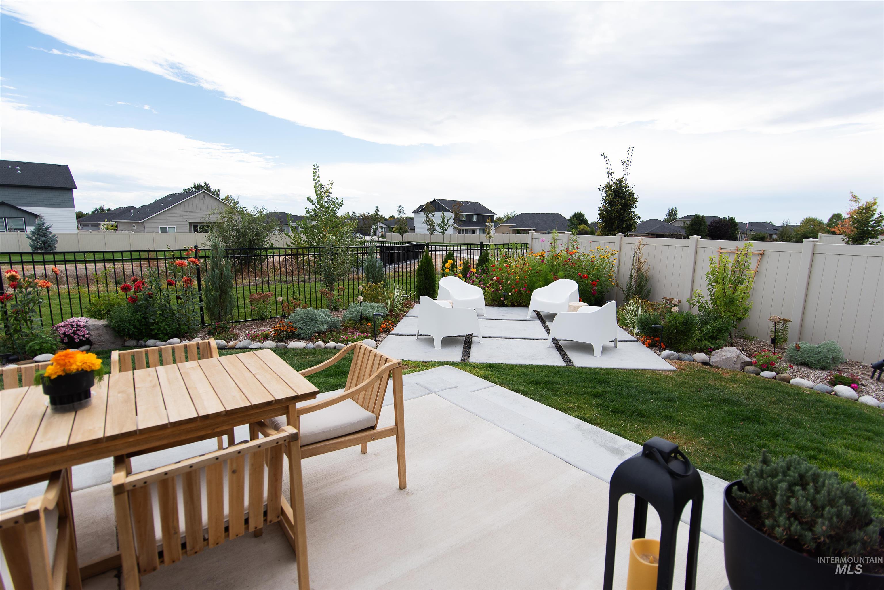 11289 West Langit Street Star, ID 83669 - Photo 3 of 33 Fenced backyard featuring a patio, outdoor dining area, and a residential view