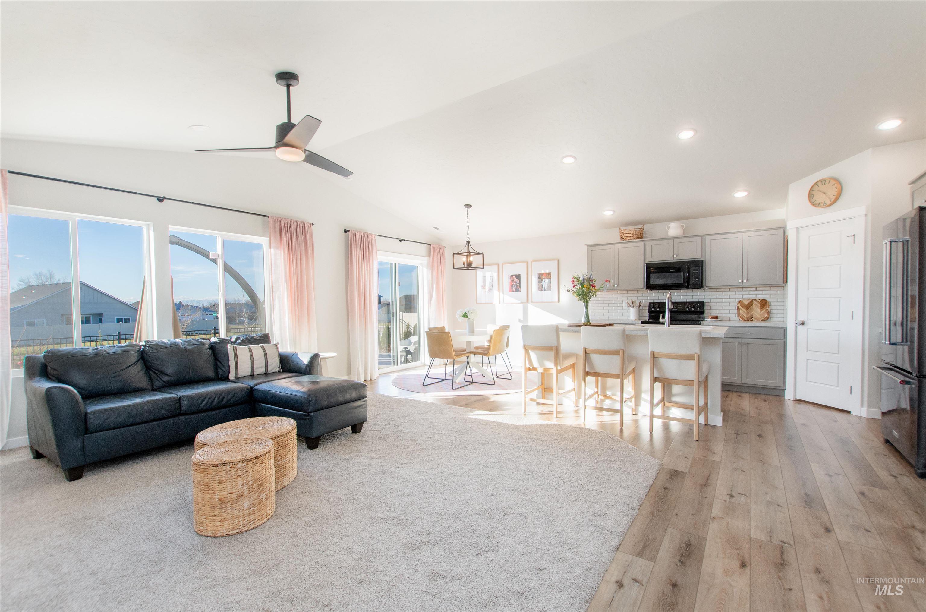 11289 West Langit Street Star, ID 83669 - Photo 6 of 33 Living room featuring lofted ceiling, recessed lighting, light wood finished floors, and a ceiling fan