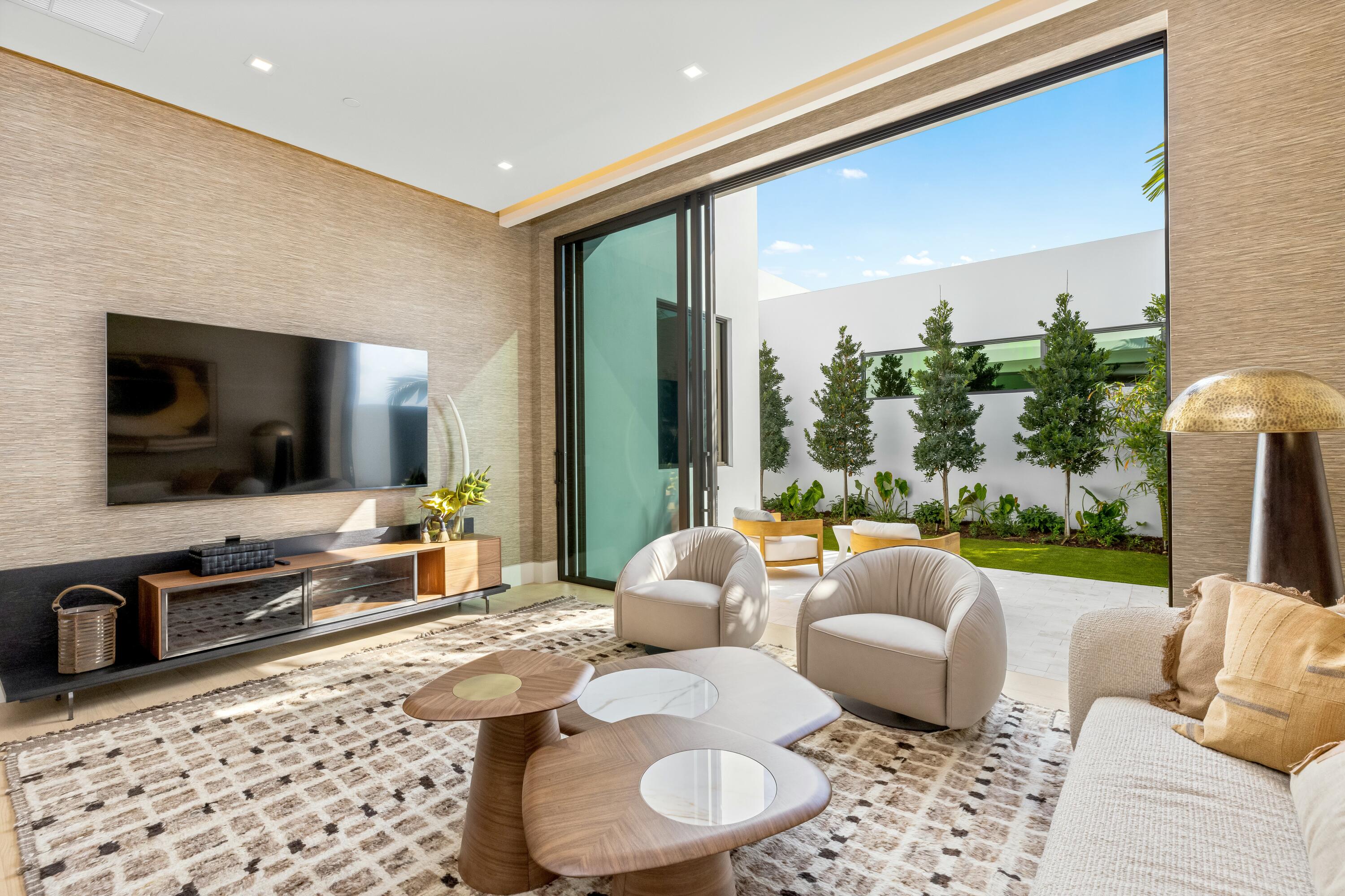 13089 Monte Rosa Court Palm Beach Gardens, FL 33412 - Photo 13 of 34 a living room with furniture and a flat screen tv