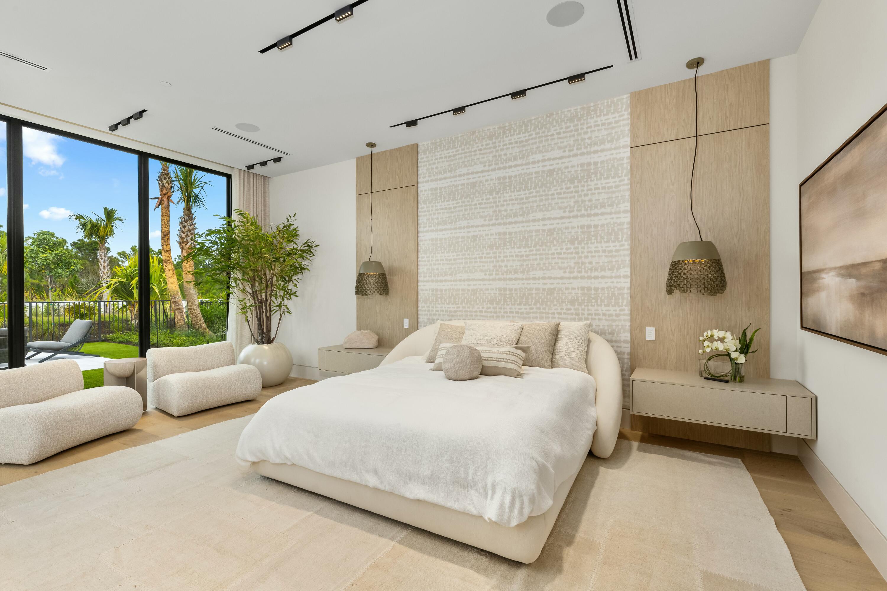 13089 Monte Rosa Court Palm Beach Gardens, FL 33412 - Photo 16 of 34 a spacious bedroom with a bed and a couch