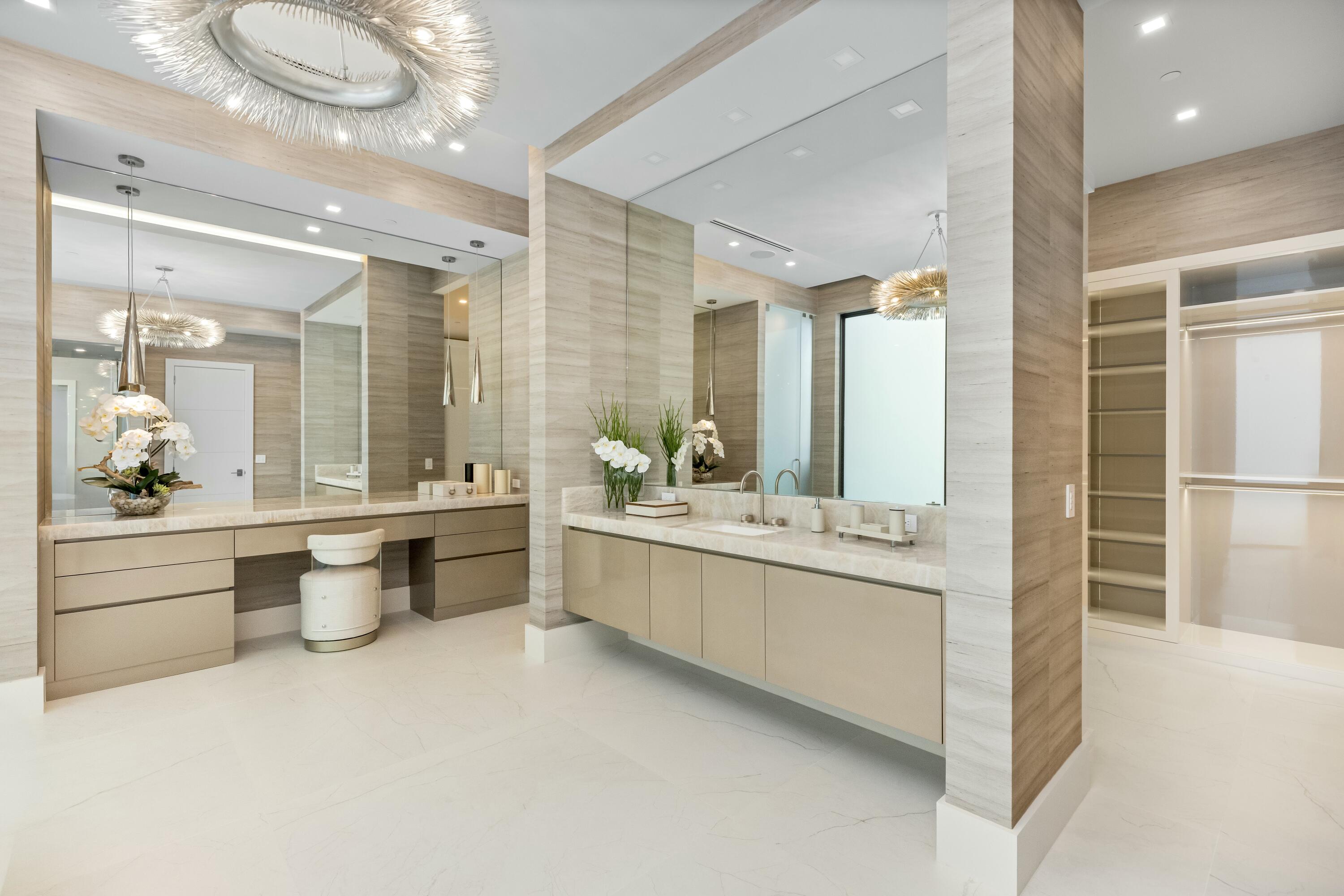 13089 Monte Rosa Court Palm Beach Gardens, FL 33412 - Photo 19 of 34 a large bathroom with a double vanity sink a large mirror and a bathtub