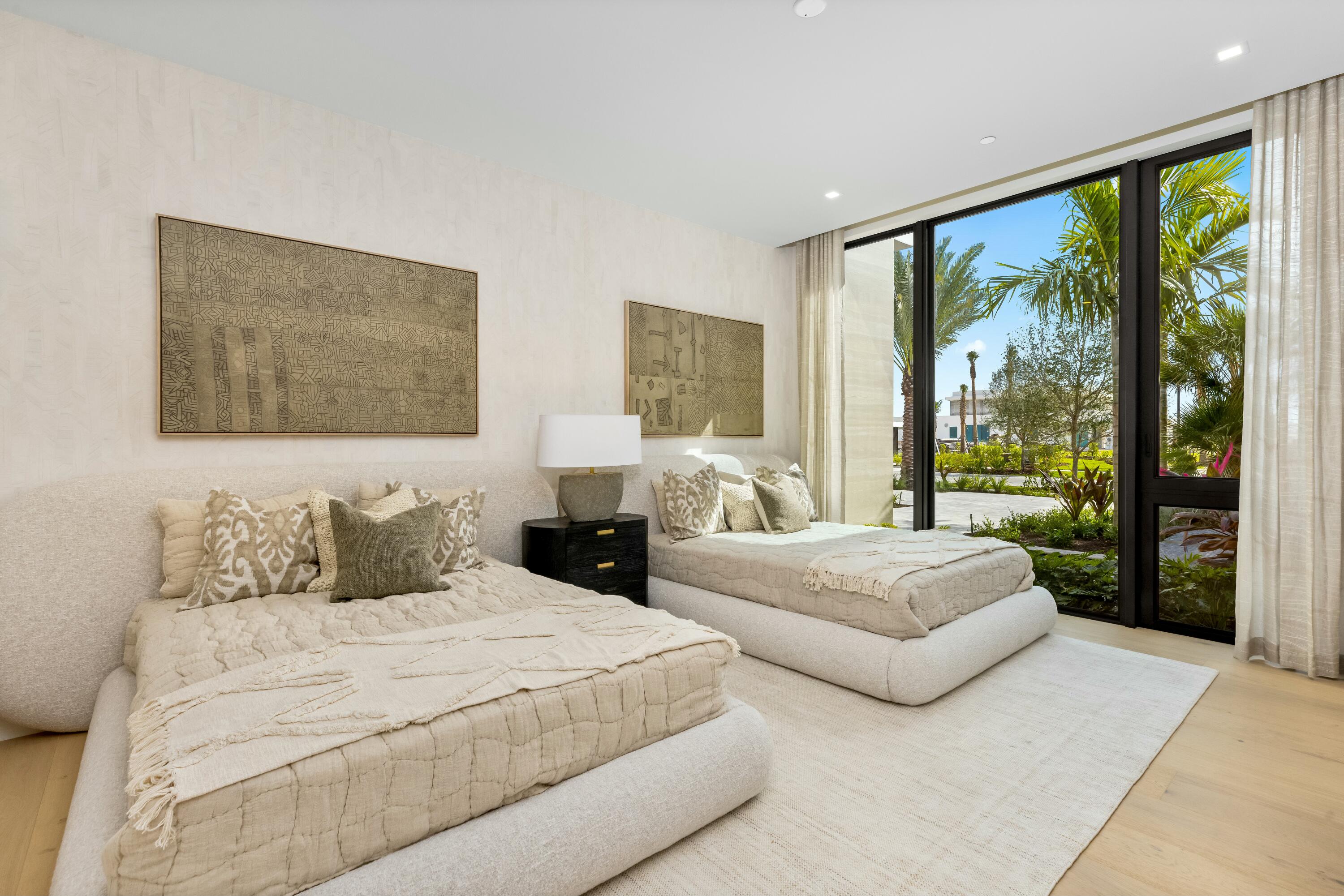 13089 Monte Rosa Court Palm Beach Gardens, FL 33412 - Photo 20 of 34 a bedroom with two large bed and a large window