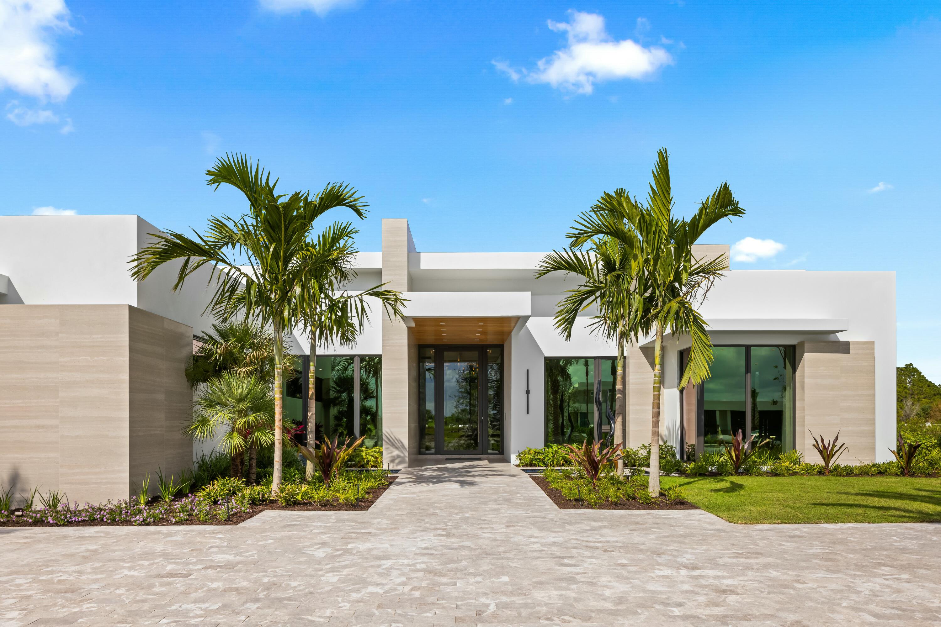 13089 Monte Rosa Court Palm Beach Gardens, FL 33412 - Photo 2 of 34 a view of a house with a yard and plants