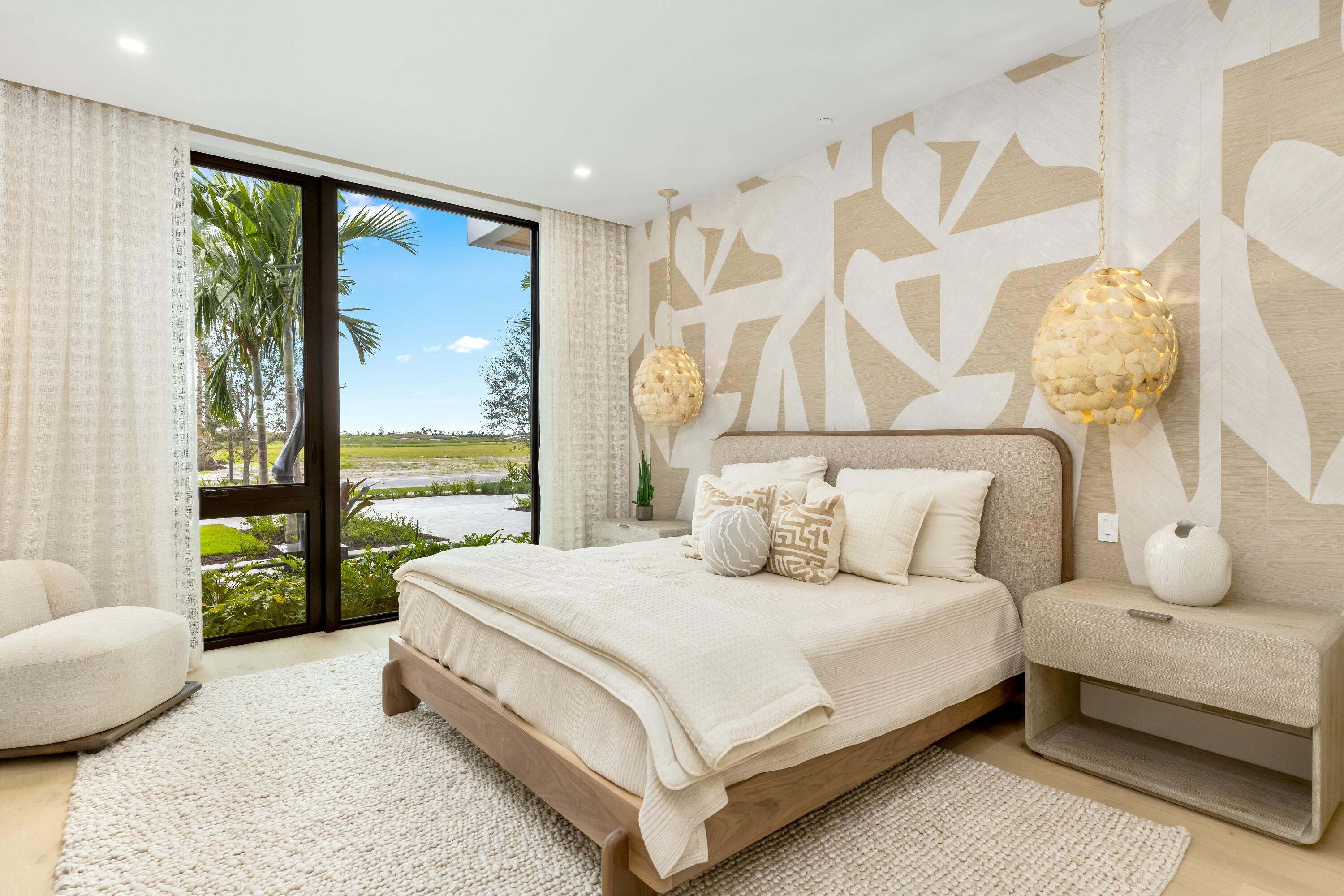 13089 Monte Rosa Court Palm Beach Gardens, FL 33412 - Photo 21 of 34 a bedroom with a bed lamp and a large window with outer view