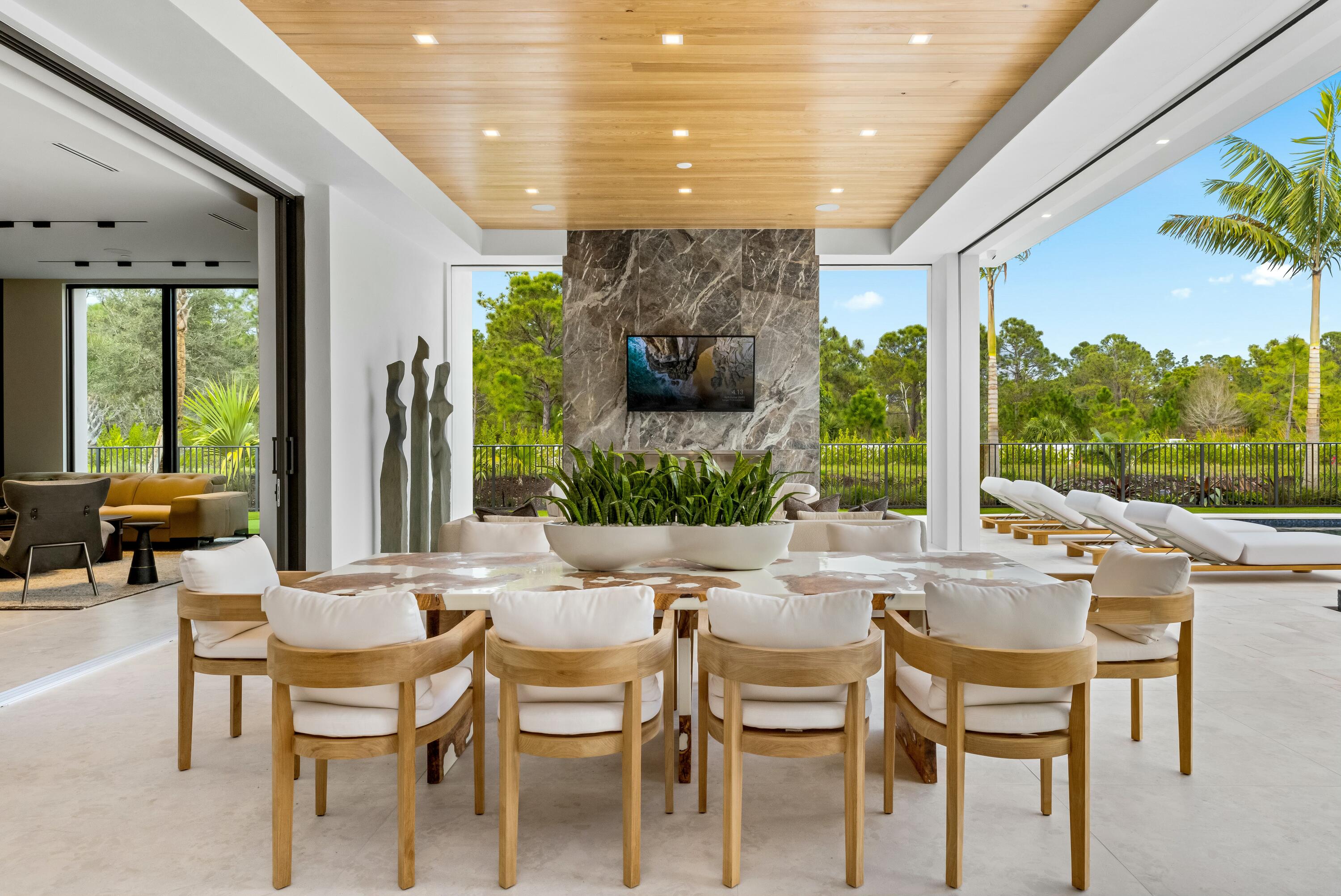 13089 Monte Rosa Court Palm Beach Gardens, FL 33412 - Photo 24 of 34 a view of an outdoor dining space with furniture and garden view