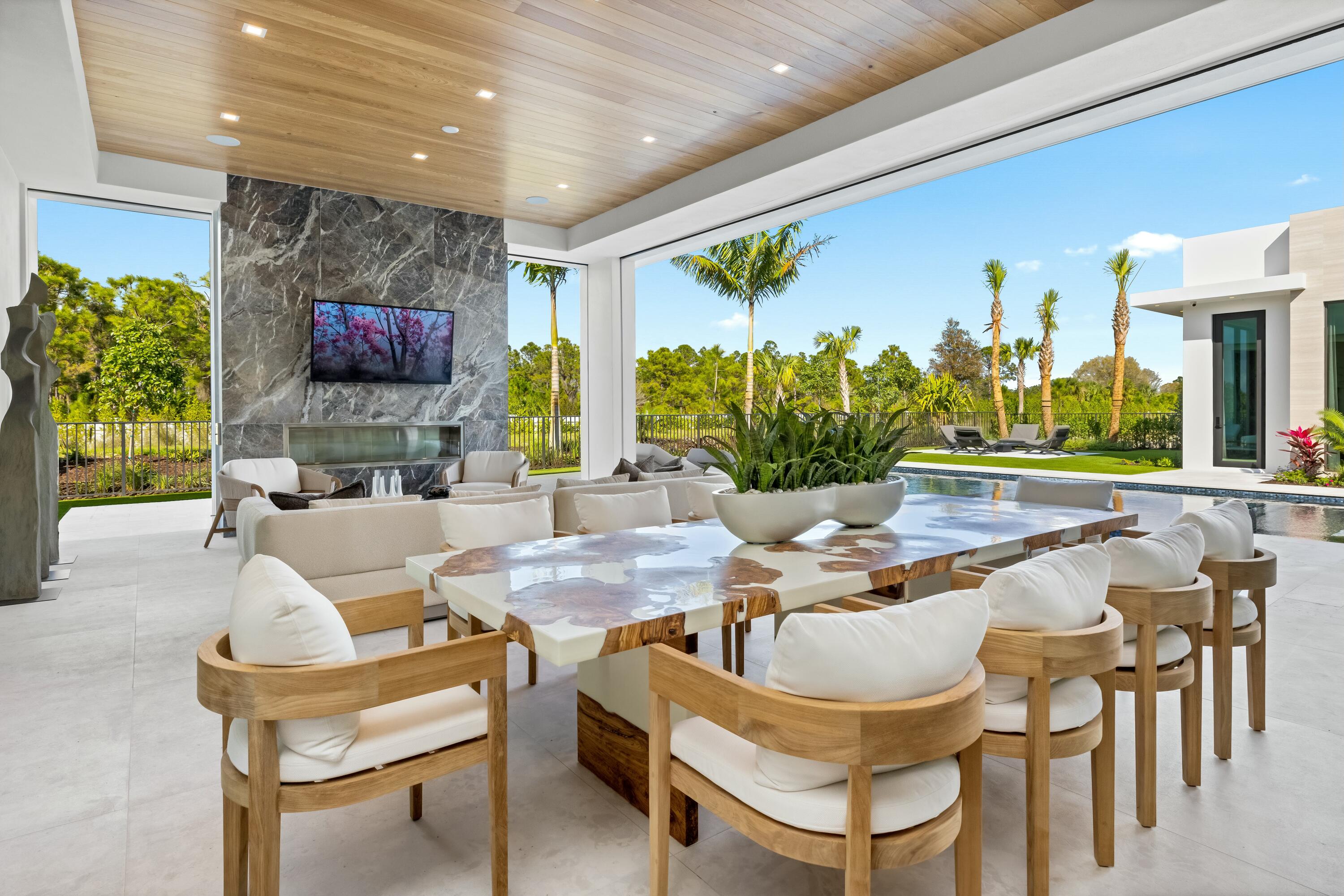 13089 Monte Rosa Court Palm Beach Gardens, FL 33412 - Photo 25 of 34 a dining room with furniture and a flat screen tv