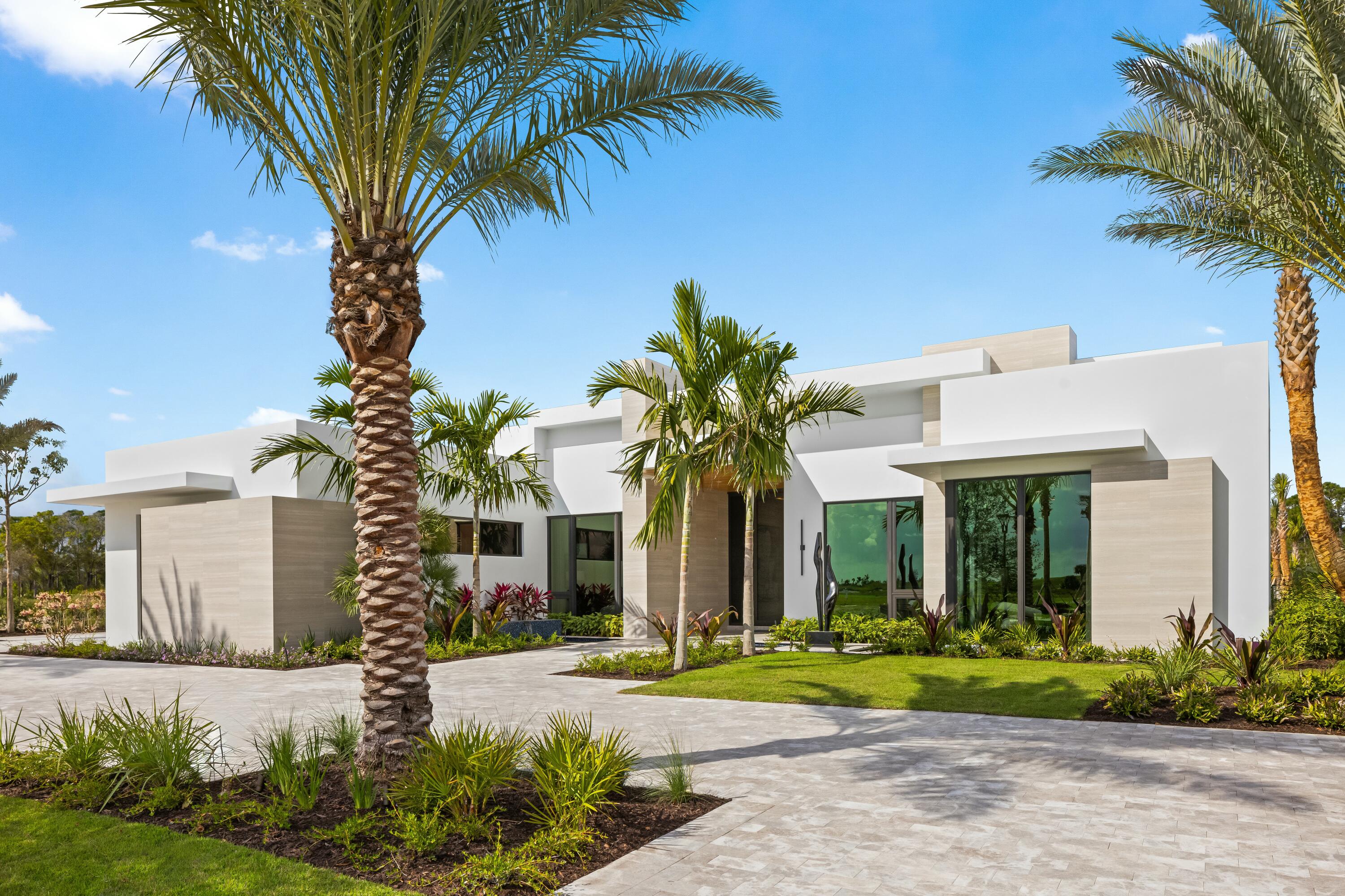 13089 Monte Rosa Court Palm Beach Gardens, FL 33412 - Photo 3 of 34 a front view of a house with garden
