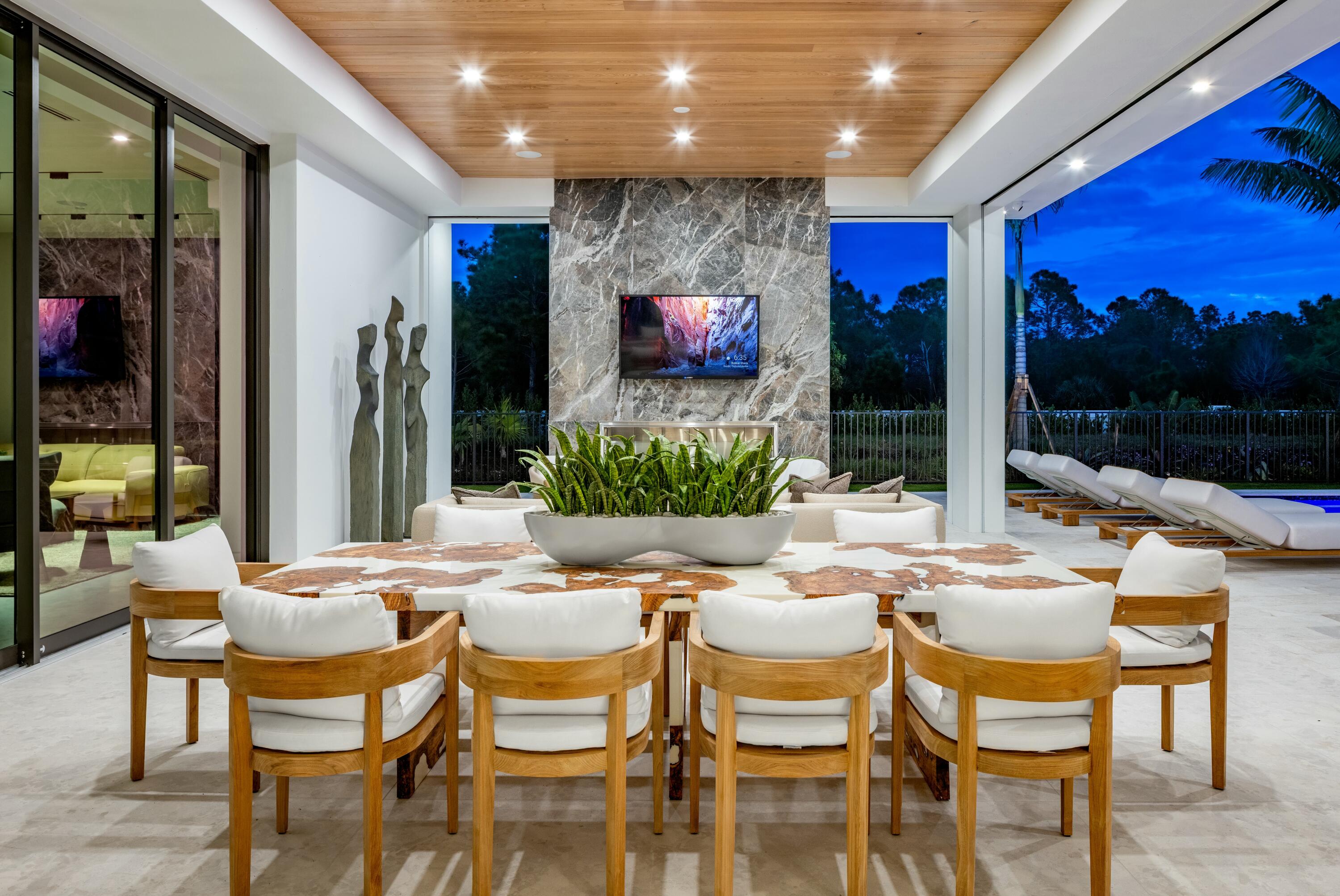 13089 Monte Rosa Court Palm Beach Gardens, FL 33412 - Photo 32 of 34 a outdoor dining space with furniture and a potted plant