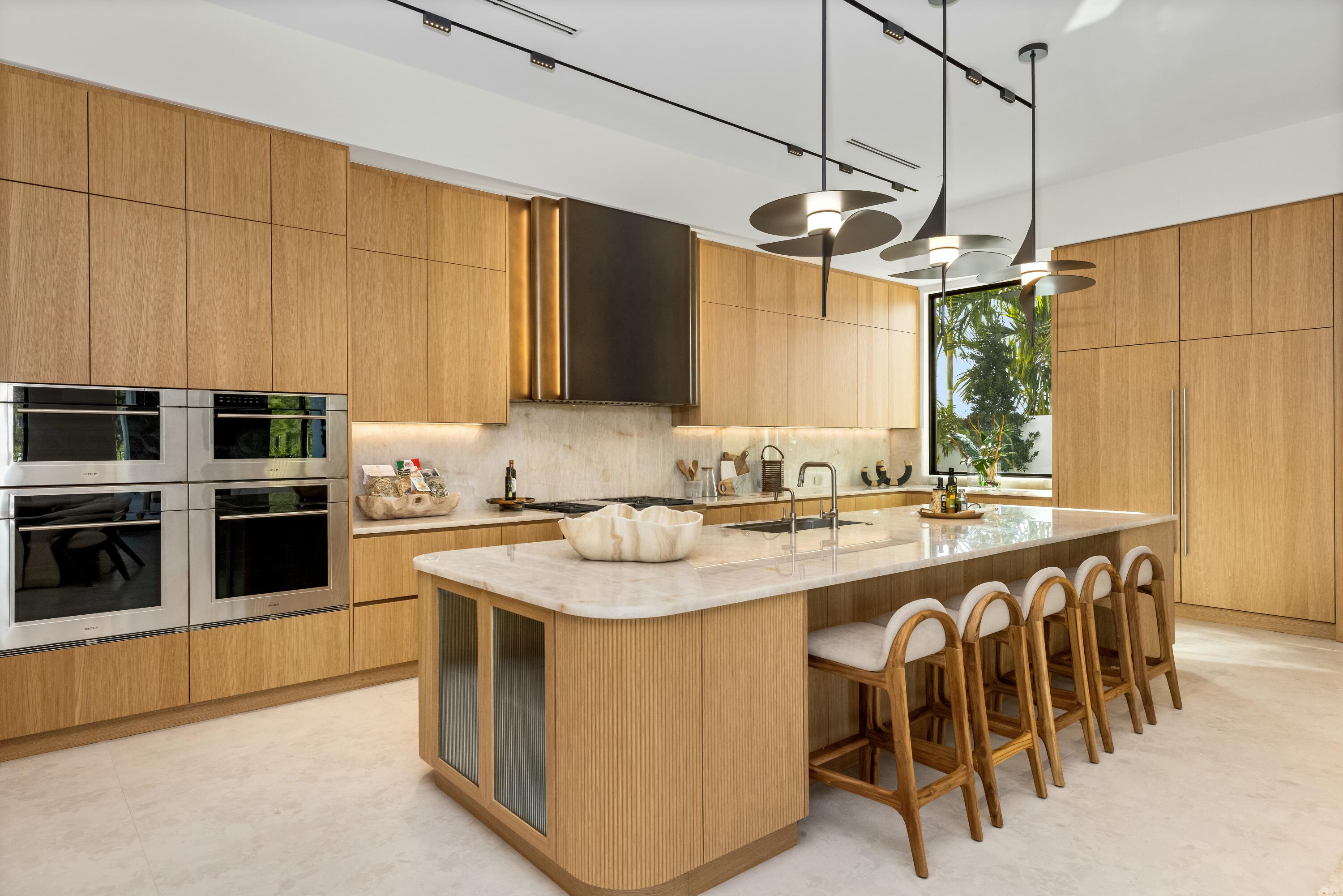 13089 Monte Rosa Court Palm Beach Gardens, FL 33412 - Photo 4 of 34 a kitchen with stainless steel appliances granite countertop a sink a stove and a refrigerator