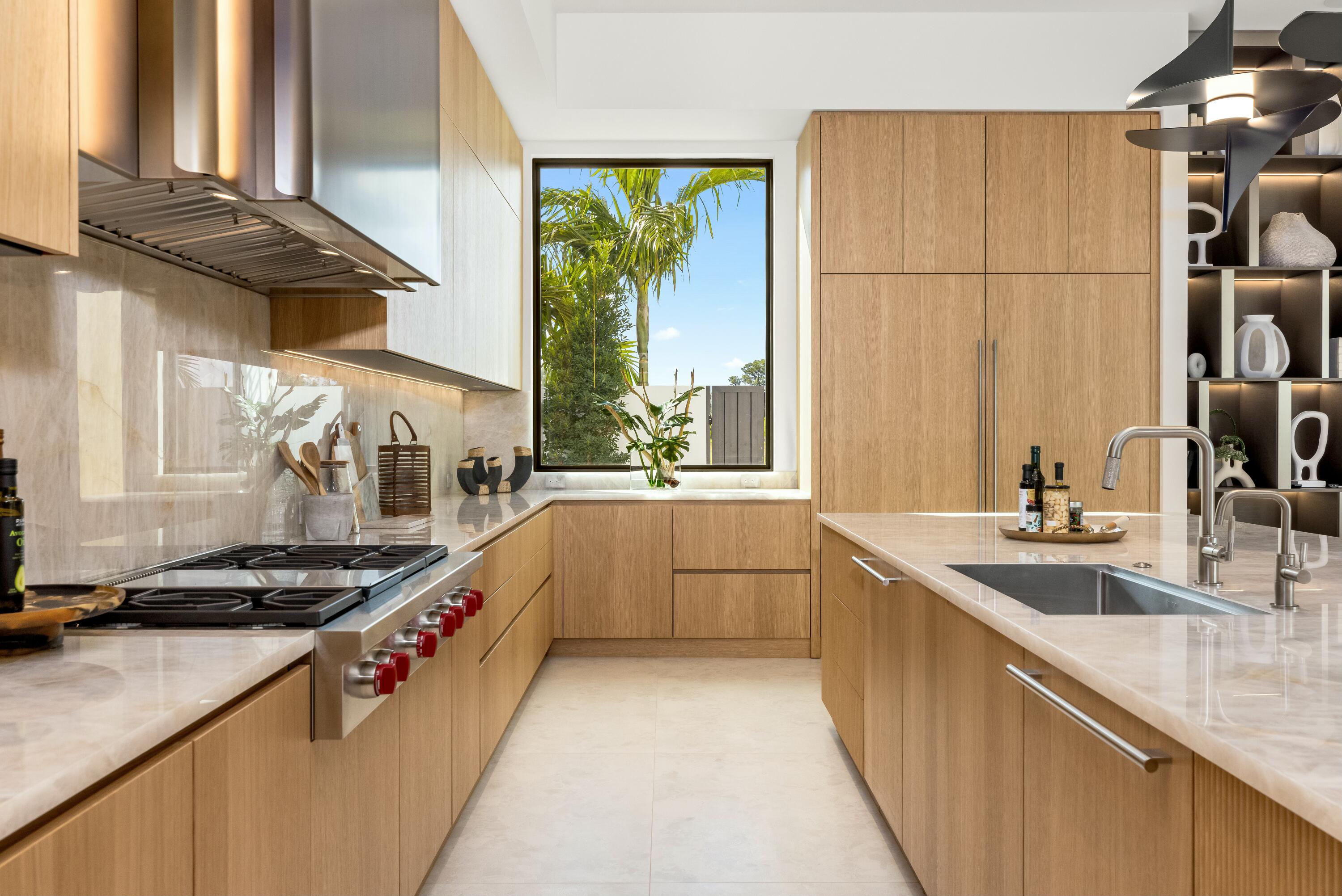 13089 Monte Rosa Court Palm Beach Gardens, FL 33412 - Photo 5 of 34 a kitchen with a sink a stove and cabinets