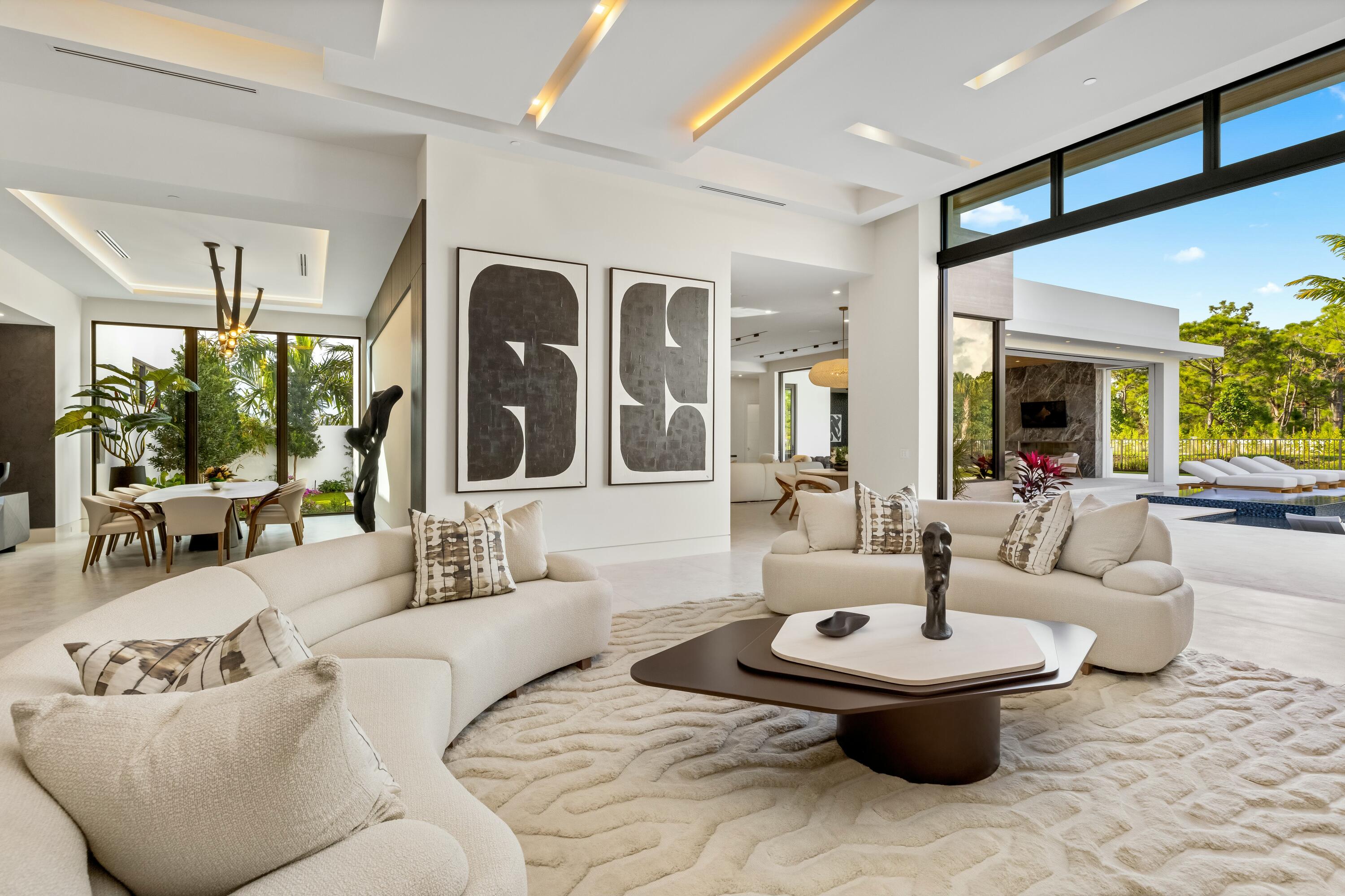 13089 Monte Rosa Court Palm Beach Gardens, FL 33412 - Photo 10 of 34 a living room with furniture and a large window