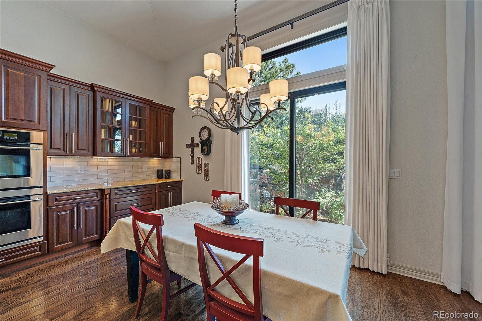 20132 East Shady Ridge Road Parker, CO 80134 - Photo 11 of 36 a kitchen with a table chairs and wooden floor