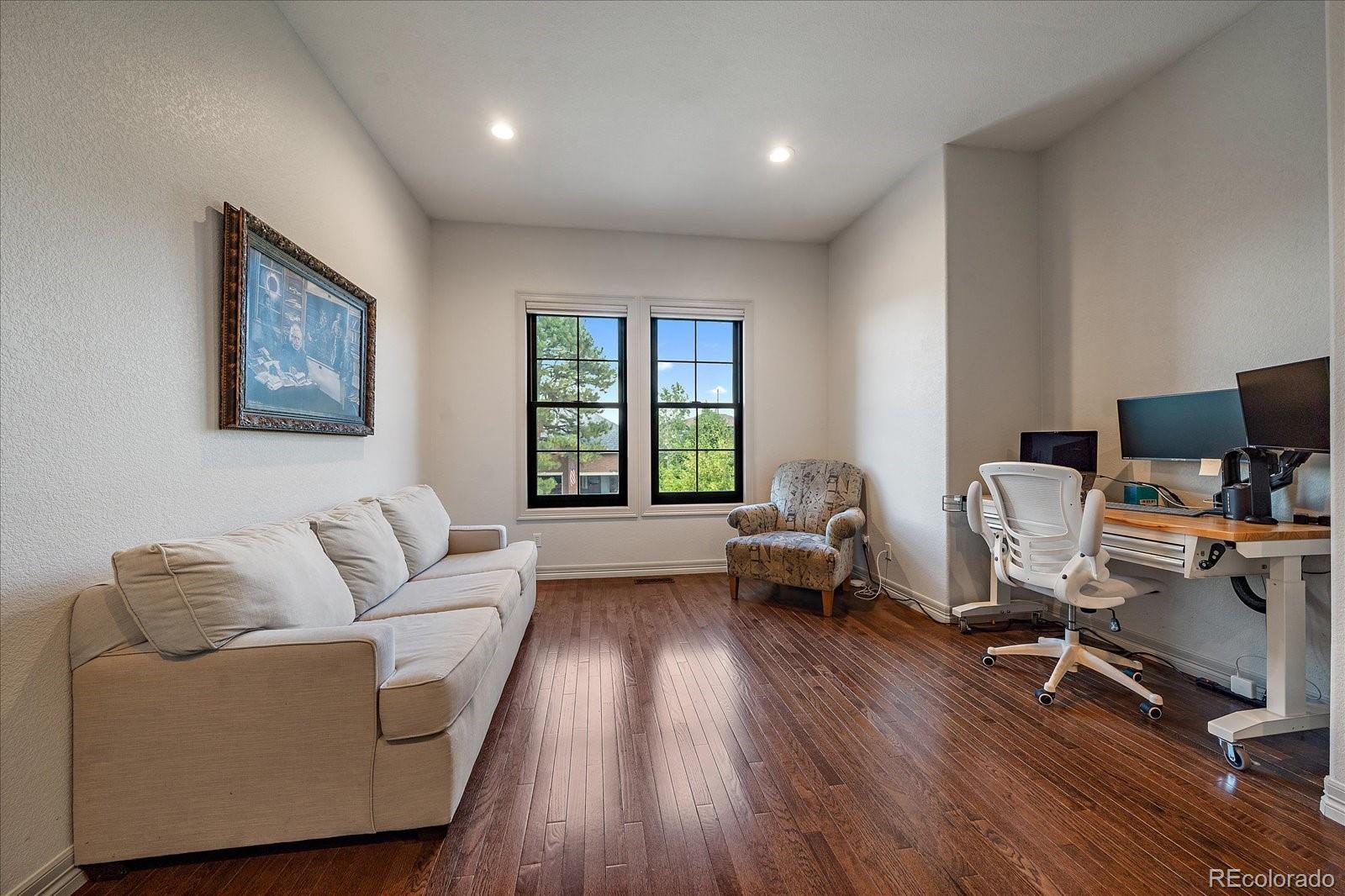 20132 East Shady Ridge Road Parker, CO 80134 - Photo 17 of 36 a living room with furniture and a wooden floor