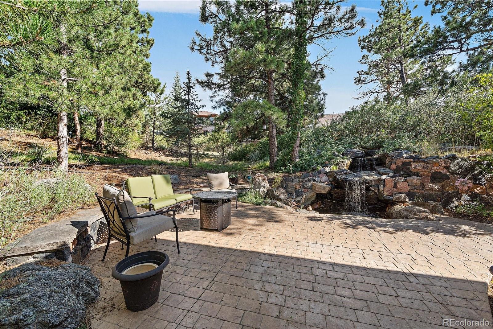 20132 East Shady Ridge Road Parker, CO 80134 - Photo 32 of 36 a view of a patio with table and chairs and couches with wooden fence and plants