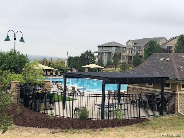 20132 East Shady Ridge Road Parker, CO 80134 - Photo 34 of 36 a front view of a house with a swimming pool