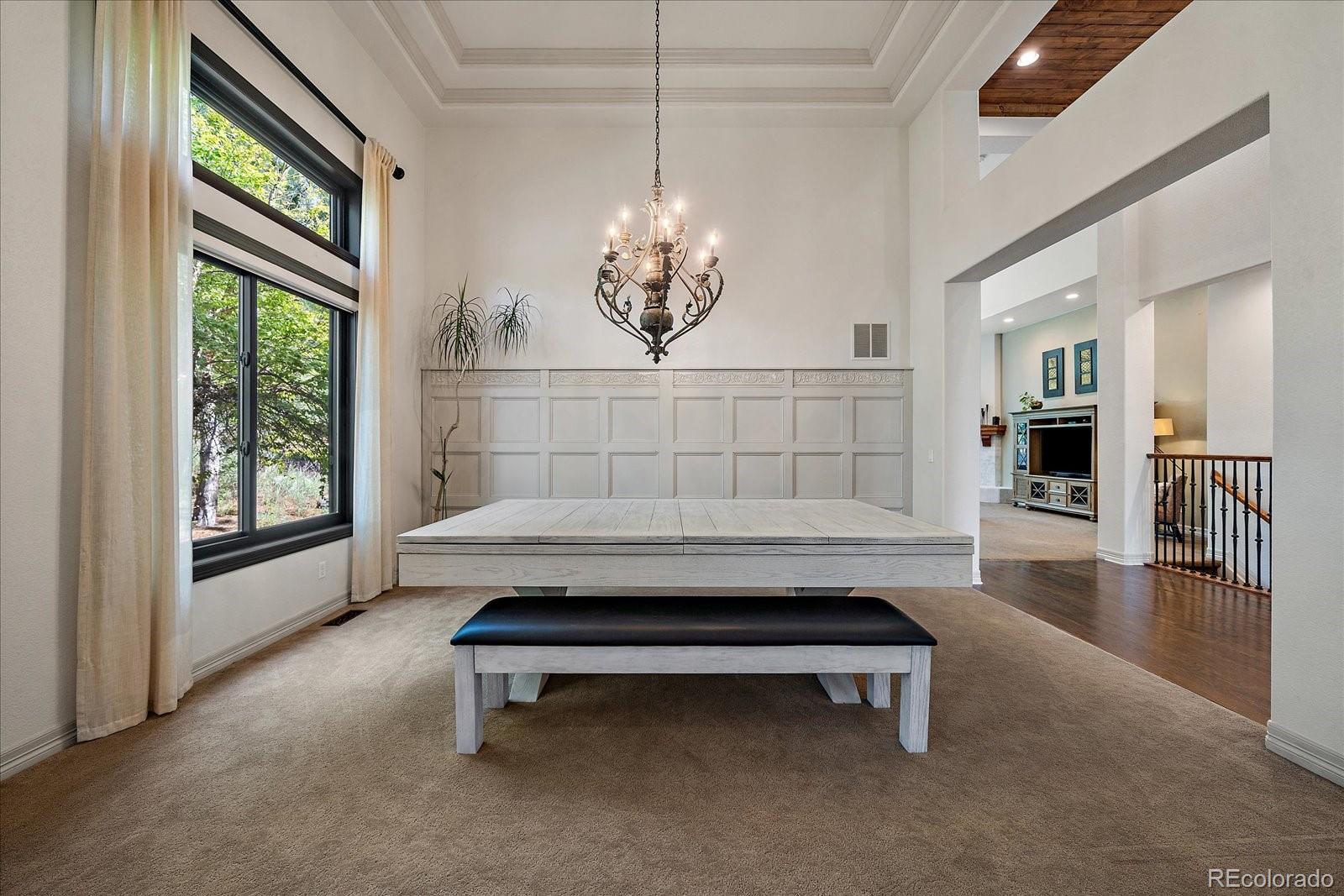 20132 East Shady Ridge Road Parker, CO 80134 - Photo 5 of 36 a living room with furniture and a chandelier