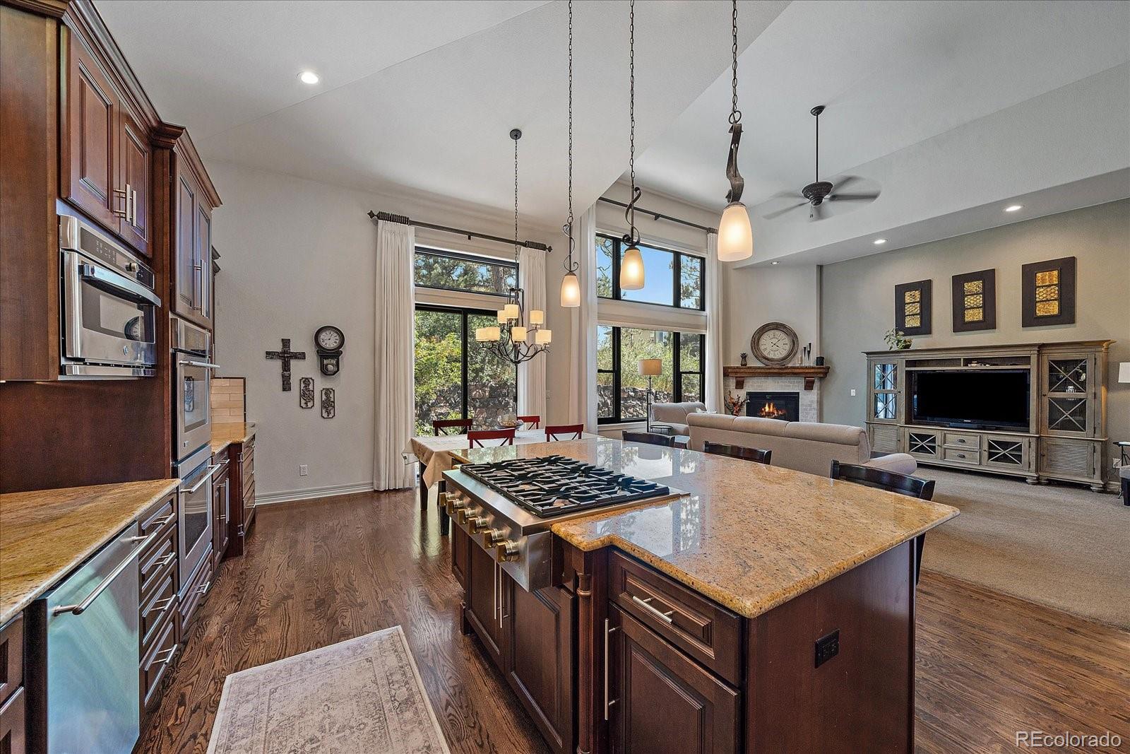 20132 East Shady Ridge Road Parker, CO 80134 - Photo 10 of 36 a kitchen that has a lot of cabinets a sink and a stove