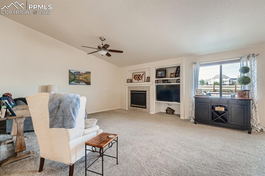 12118 Rio Secco Road Peyton, CO 80831 - Photo 11 of 23 a living room with furniture and a fireplace