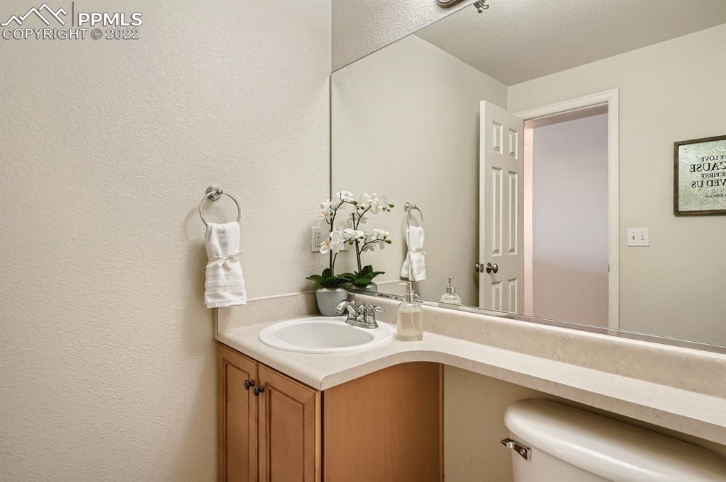 12118 Rio Secco Road Peyton, CO 80831 - Photo 16 of 23 a bathroom with a sink and a mirror