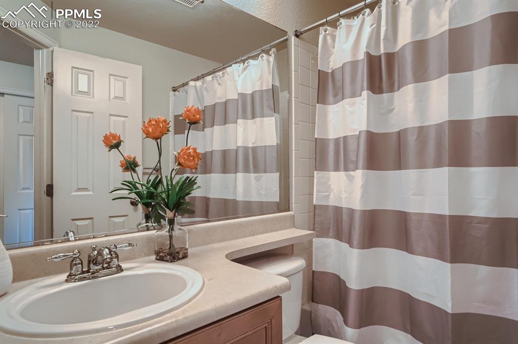 12118 Rio Secco Road Peyton, CO 80831 - Photo 17 of 23 a bathroom with a sink and a mirror