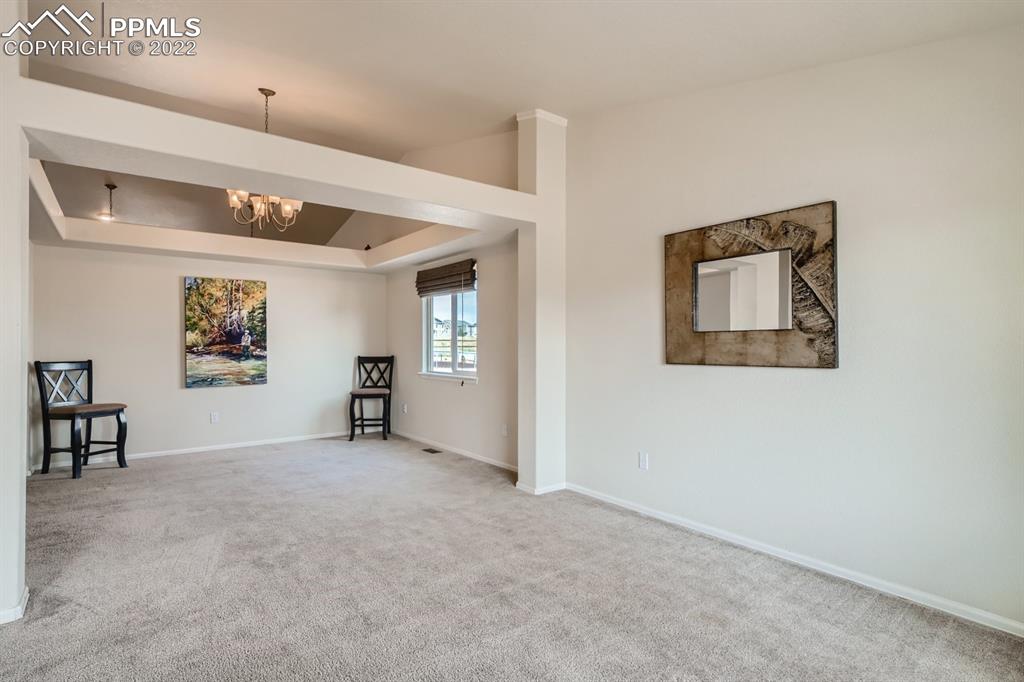12118 Rio Secco Road Peyton, CO 80831 - Photo 4 of 23 an empty room with windows and furniture