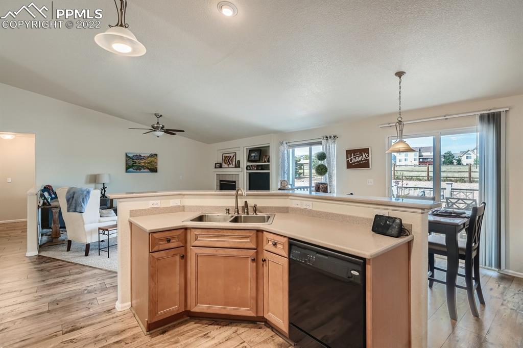 12118 Rio Secco Road Peyton, CO 80831 - Photo 8 of 23 a kitchen that has a sink a stove and a table