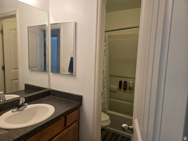 90 East Resaca Drive, Unit C11 Sandy, UT 84070 - Photo 14 of 27 Full bathroom with vanity, shower / tub combo with curtain, and a textured wall