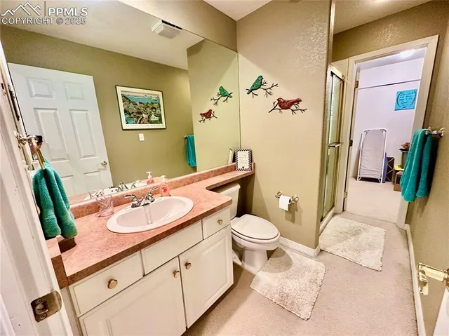 a bathroom with a sink vanity granite and toilet