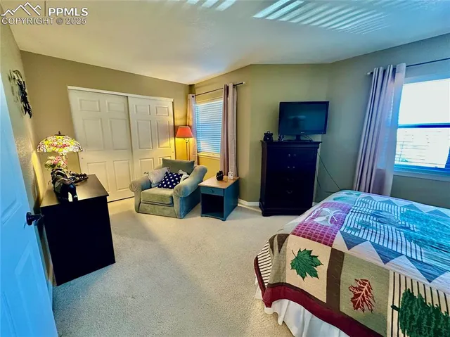 a bedroom with furniture and a window