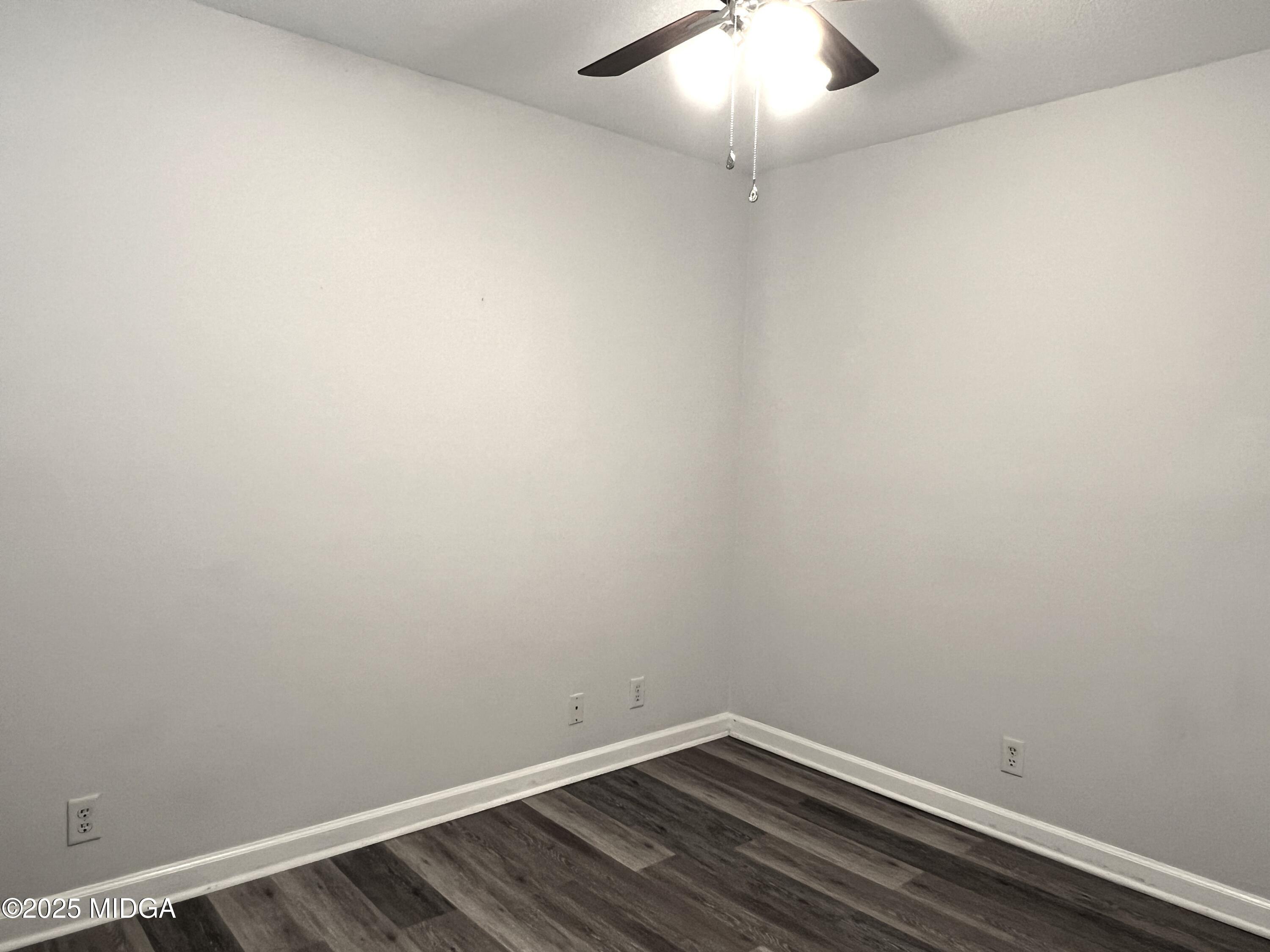 1149 Runnymede Lane Macon, GA 31220 - Photo 11 of 25 an empty room with wooden floor and fan