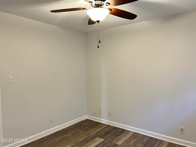 a view of a room with wooden floor