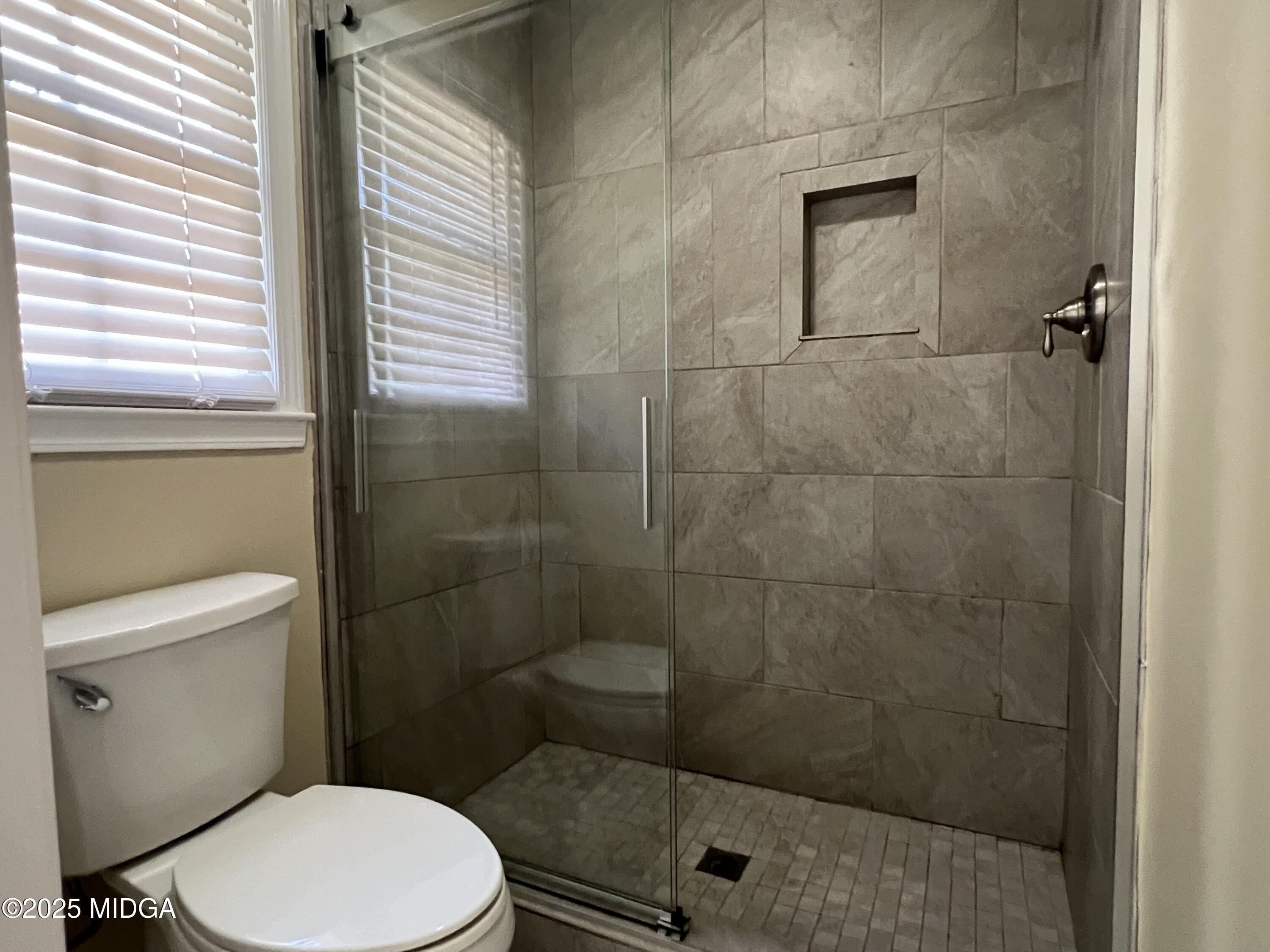 1149 Runnymede Lane Macon, GA 31220 - Photo 20 of 25 a bathroom with a toilet and a shower