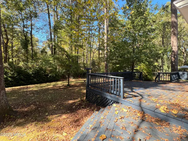 a view of street with wooden fence