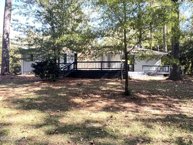 a view of a yard with plants and trees