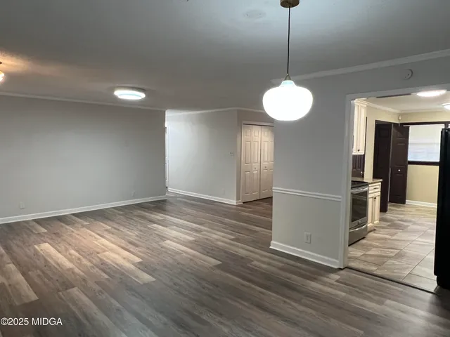 a view of a room with wooden floor and a window