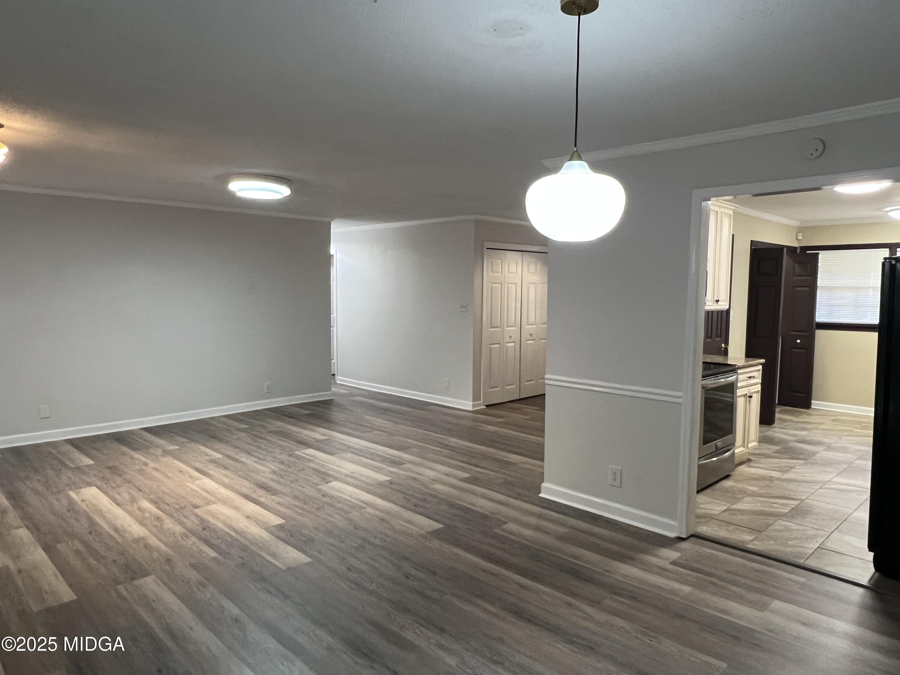 1149 Runnymede Lane Macon, GA 31220 - Photo 5 of 25 a view of a room with wooden floor and a window