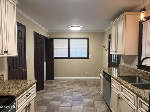 a kitchen that has a sink and a stove